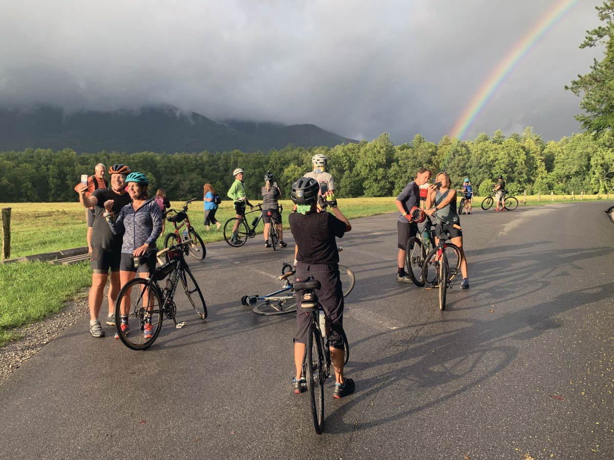 Cyclists photograph a rainbow over Cades Cove during a Wednesday ride. NPS photo