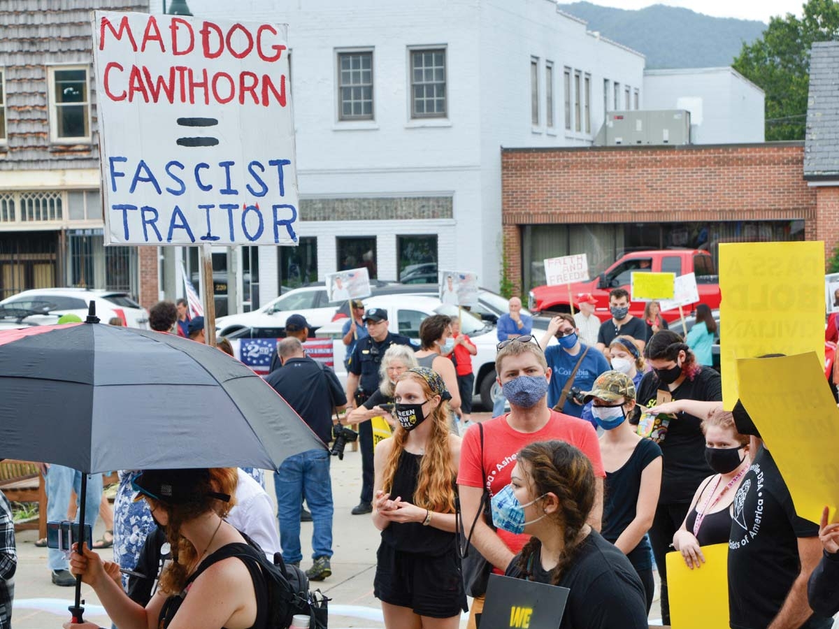 A group of Cawthorn supporters from the Haywood County GOP (background) watches as anti-Cawthorn demonstrators hold a rally Sept. 19. Cory Vaillancourt photo