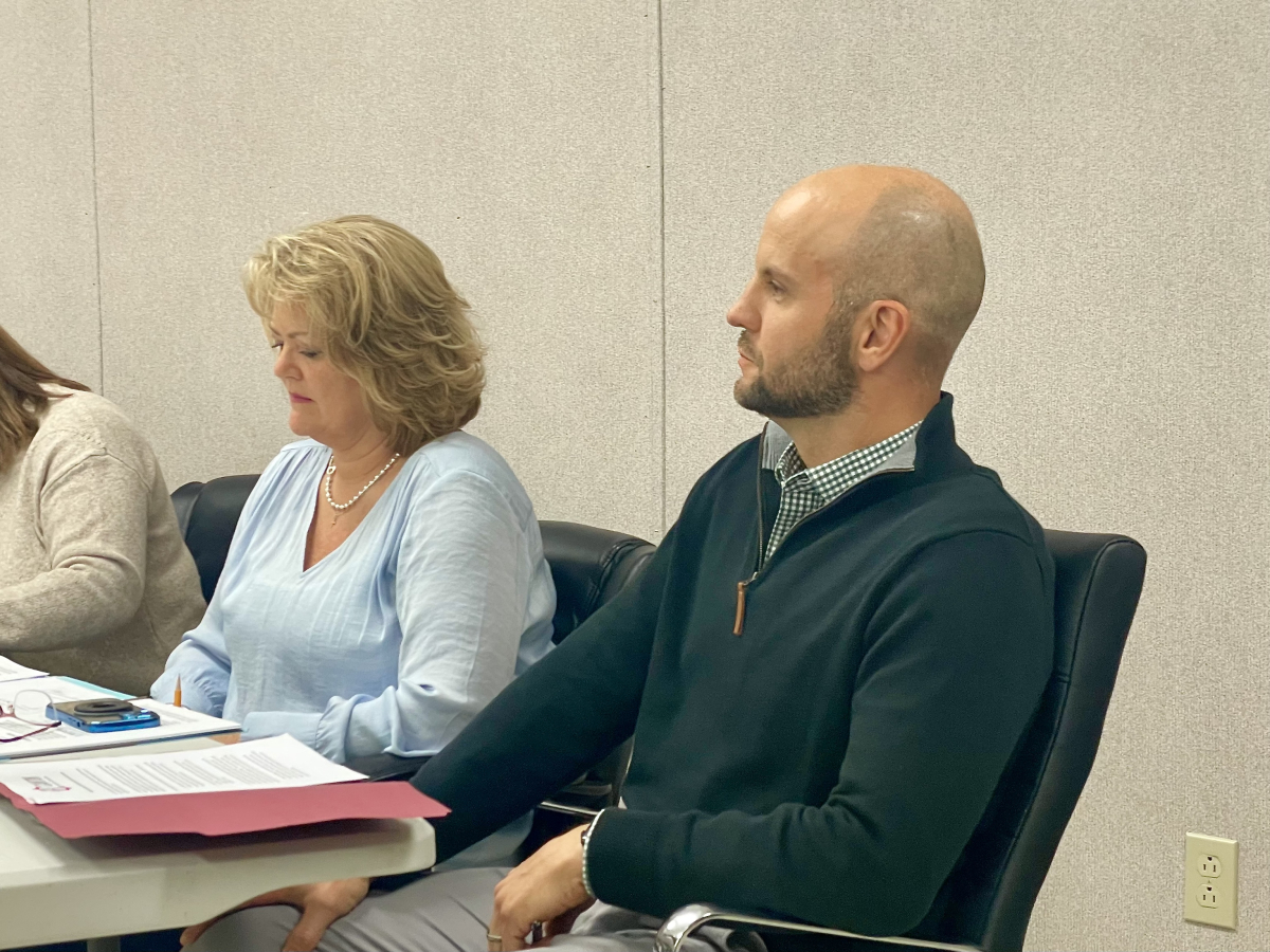 Canton Assistant Town Manager Lisa Stinnett (left) and Town Manager Nick Scheuer listen to speakers during a meeting of the Town of Canton Board of Aldermen/women moments before assuming their new roles.