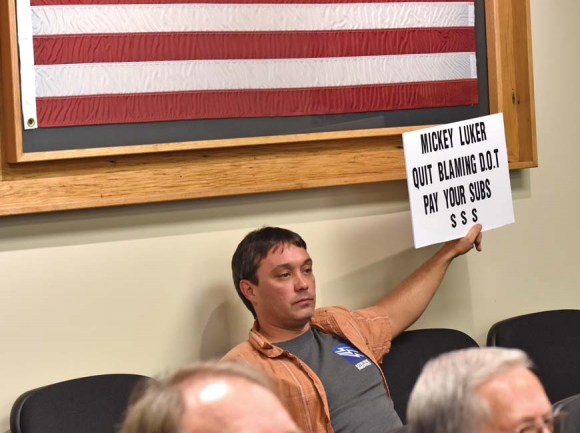 Blitz Estridge holds up a sign expressing his plight during a Feb. 19 Jackson County Commissioners meeting. Holly Kays photo