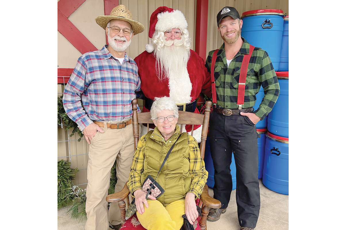 Burt (left), Becky and Henry Kornegay stand with “Santa” during the Tuckasegee Trading Company’s annual hoedown. Marianna Coyle photo 