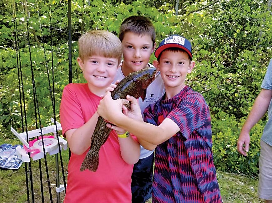 The winner of the largest fish contest in the 2019 Kids Fish Day at Max Patch Pond shows off his catch. Donated photo