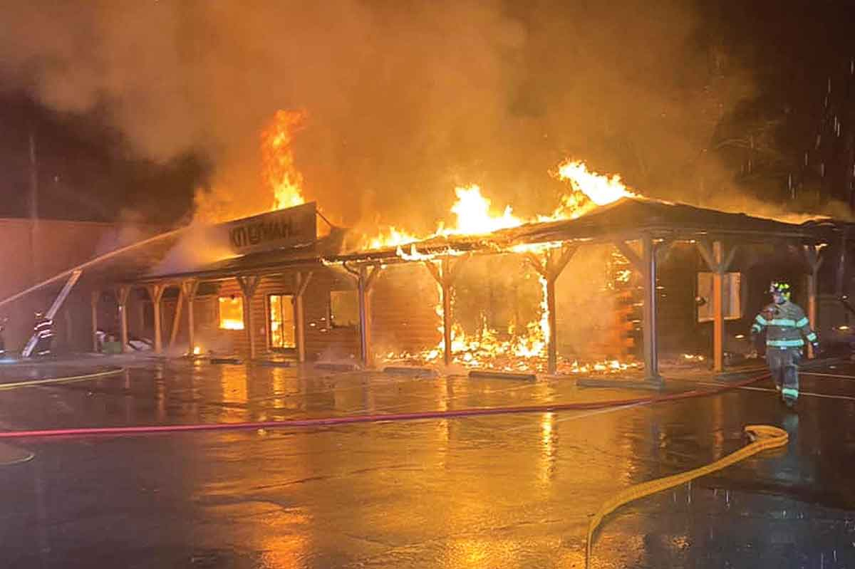 A firefighter walks away from the burning Kituwah LLC building. EBCI Cherokee Fire and Rescue photo