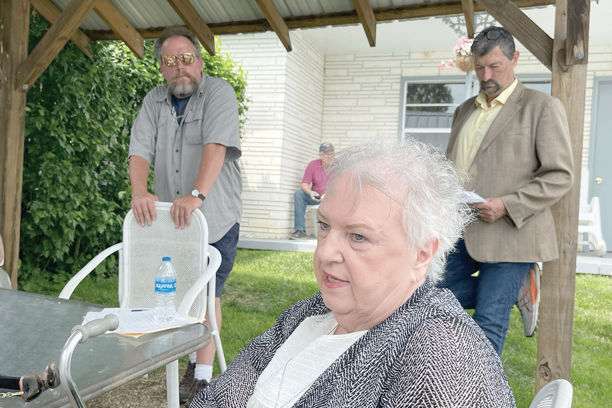 Maggie Valley resident Linda Taylor (center) recalls her attempt to develop an RV park while Alderman Phillip Wight (left) and Rep. Mark Pless(right) look on. Kyle Perrotti photo