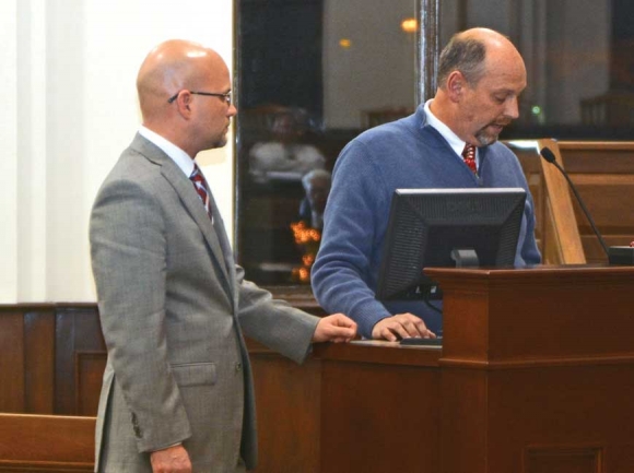 Haywood County Tax Collector Mike Matthews (left) confers with his predecessor David Francis at a meeting of the Haywood Commissioners. File photo