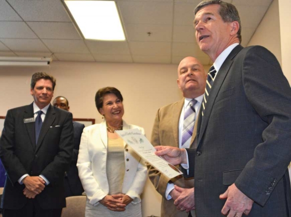 Judge Brad Letts (left to right) and Susan Belcher look on as WCU Chancellor Dr. David Belcher receives the Order of the Long Leaf Pine from Gov. Roy Cooper. Cory Vaillancourt photo