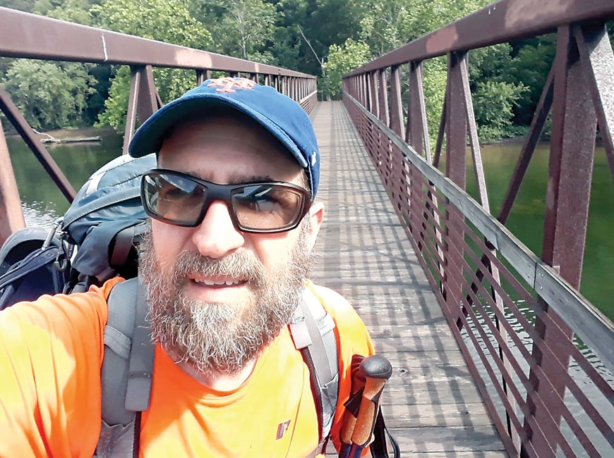 Joe ‘Triton’ Schmidt, founder of the Facebook group Still on the A.T, crosses the James River during an 800-mile section hike last year. Donated photo