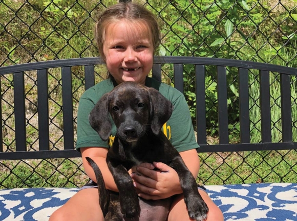 A camper enjoys the chance to cuddle a shelter pup. CHHS photo