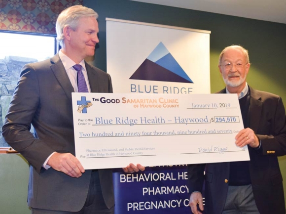 David Riggs, former board chairman for Good Samaritan Clinic, (right) presents Blue Ridge Health CEO Dr. Richard Hudspeth with a check for $294,970. Jessi Stone photo