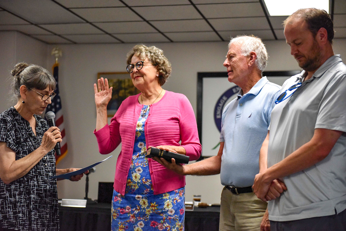 Gayle Woody (center left) was sworn in as the newest member of the board of education on June 25. Hannah McLeod photo 