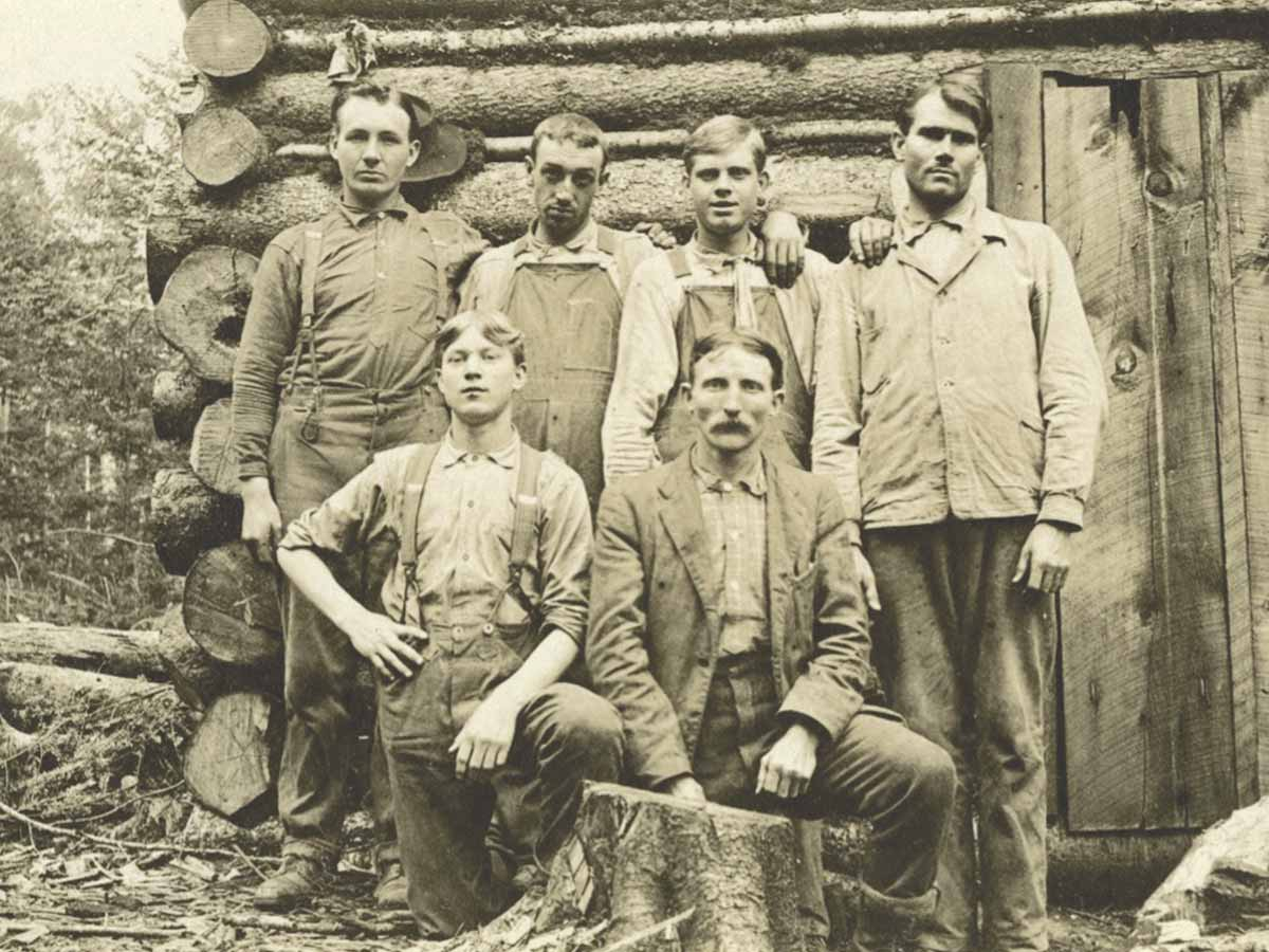 Dr. Carl Schenck is shown here (front row, right) posing with his students at the Boomer Inn cabin. Note that in the left background is the stable where their horses were sheltered. Donated photo
