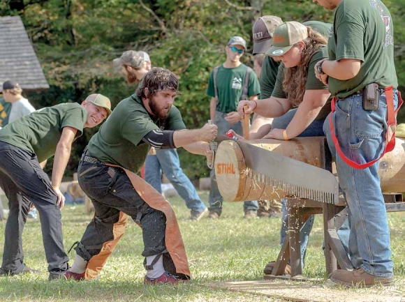 HCC students saw through a log during a timbersports competition. Phillip Turner photo