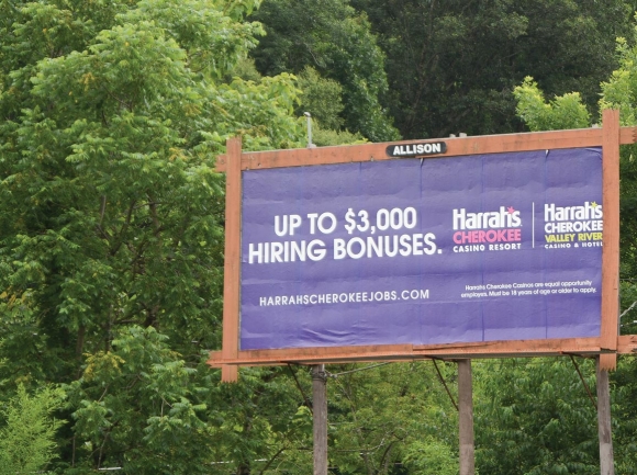 Billboard signs all along U.S. 74, like this one just outside of Waynesville, advertise Harrah’s financial incentives for new hires. Holly Kays photo