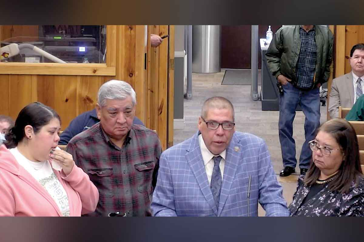 Bill Taylor addresses Tribal Council Feb. 1, surrounded by (from left) his daughter Nichole Roberts,  father-in-law Morgan Calhoun and wife Katrina Taylor. EBCI photo