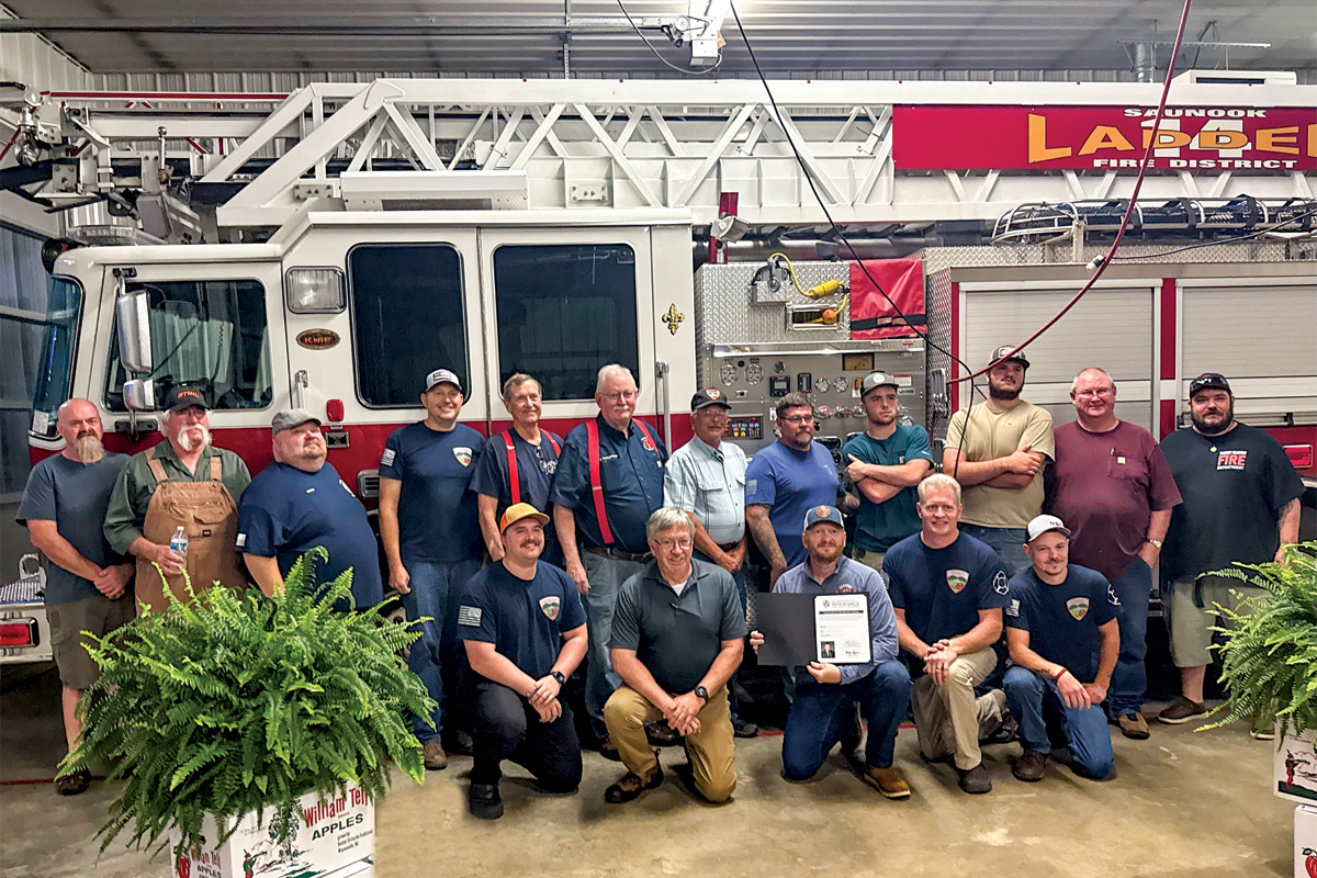 The volunteers of the Saunook Fire Department pose proudly in front of their ladder truck after receiving their new ISO rating. 