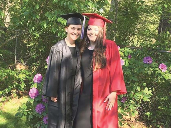Lily Payne (left) poses in cap and gown with her sister, Olivia. Shannon Stokely photo