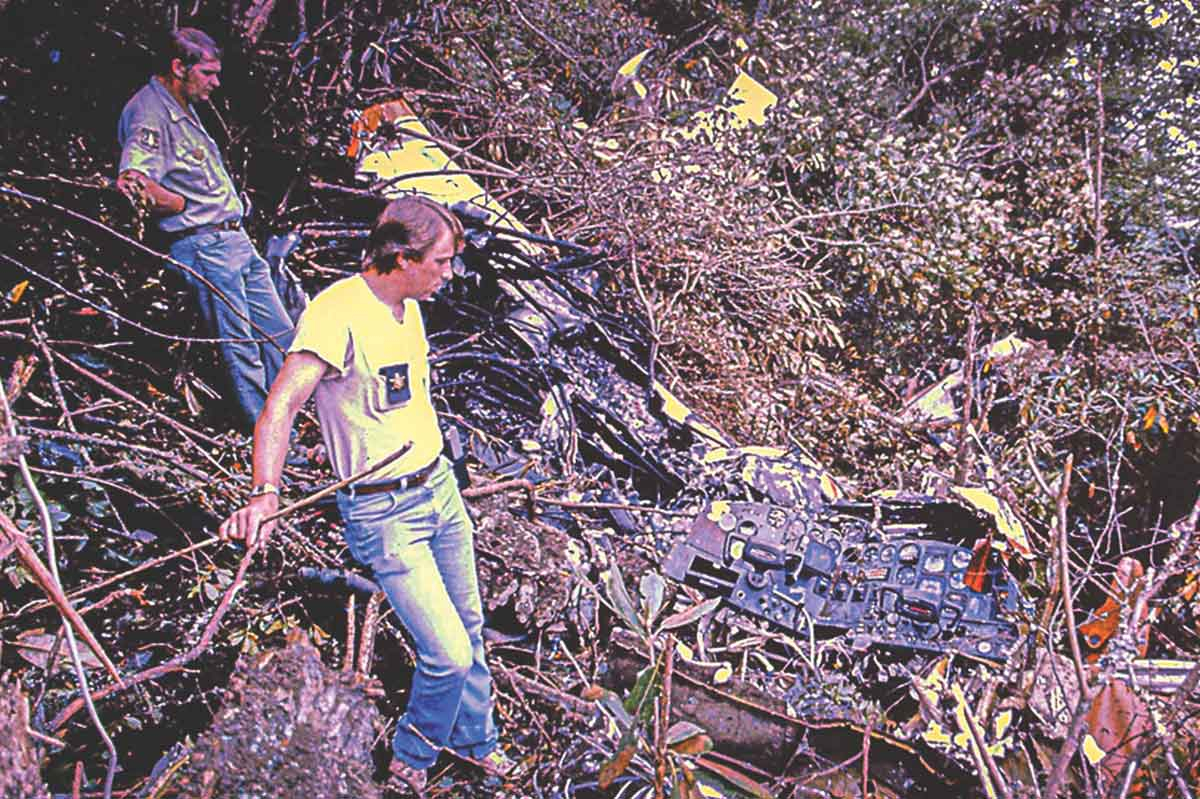 Dale Holland with the United States Forest Service (left) and Bud Talley of the Macon County Sheriff’s Office at the scene of the cocaine ghost airplane in September 1985. Photo courtesy of Bob Scott