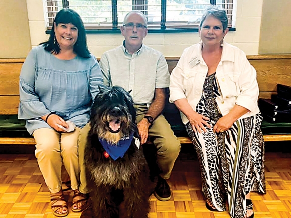 Hospice Executive Director Andrea Rogers-Ray, (from left) volunteer Bill Hoke and Cody, and Hospice Volunteer Coordinator Beverly Murray are pictured at a volunteer appreciation event.  